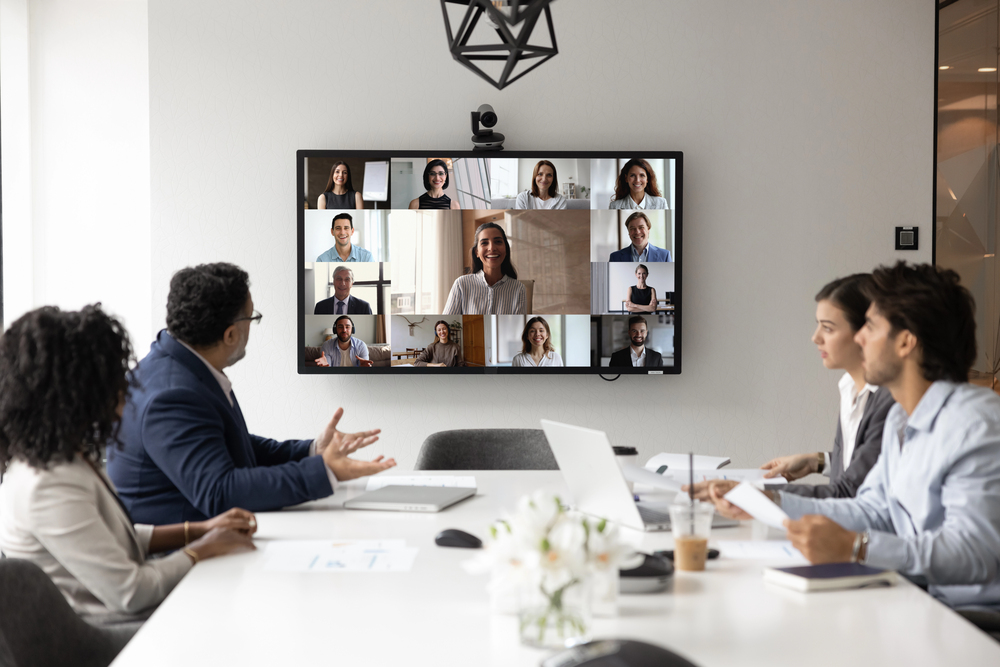 hybrid meeting with remote participants on screen